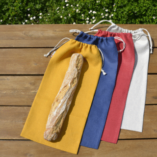 4 sacs à pain en lin de la marque Les extra-ordinaires, posés sur une table